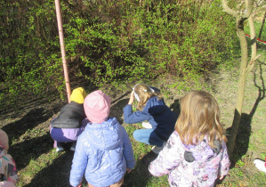 Dzieci szukają jajek w ogrodzie przedszkolnym